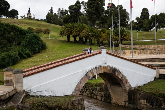 Female tourist taking pictures at the famous historic Bridge of Boyaca in Colombia. The Colombian independence Battle of Boyaca took place here on August 7, 1819.
