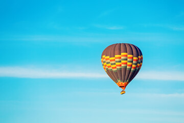 Fototapeta na wymiar Hot air balloon in the blue sky. Cappadocia, Turkey. Postcard. Place for text