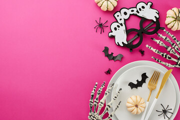 Infusing your table with the spirit of Halloween celebration. Top view arrangement of ghostly eyewear, scary skeleton hands, pumpkins, creepy decorations on pink background with marketing space