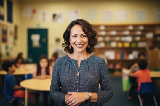 Smiling portrait of a middle aged caucasian elementary school teacher teaching a class of students