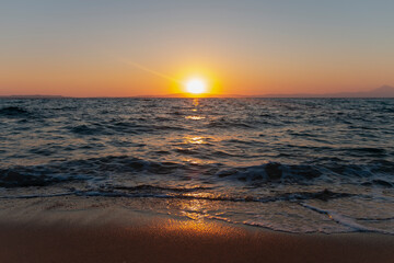 Fototapeta na wymiar Beautiful nature with sunrise on the beach and sea or ocean. Nature composition.