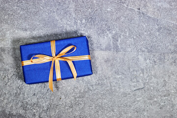 rectangle blue gift box with copy space on gray grunge background. flat lay