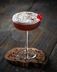 Vibrant Red Cocktail: A Taste of Elegance on a Wooden Table