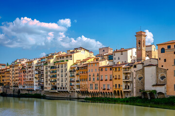 View of Lungarno degli Acciaiuoli. Old buildings by the northern bank of river Arno in the afternoon, on a sunny day.