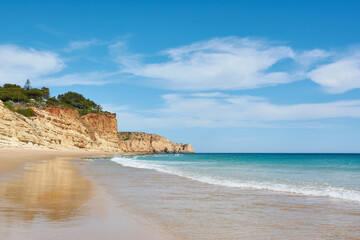 Fototapeta na wymiar Amazing beach Porto de Mos, Portugal. High cliffs and azure ocean water
