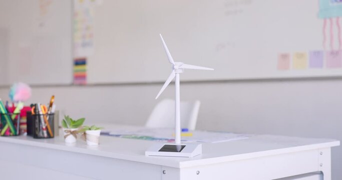 Renewable energy, wind turbine and classroom at school, innovation and windmill model on table for sustainability. Eco friendly, environment and stationary on desk for student learning and education