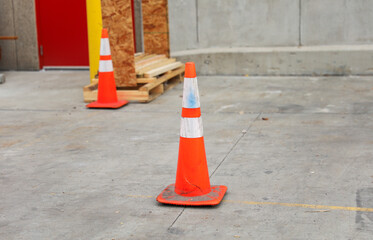 construction cone on the road signifies ongoing progress, caution, and temporary disruption in the...