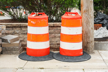 construction cone on the road signifies ongoing progress, caution, and temporary disruption in the...