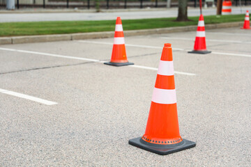 construction cone on the road signifies ongoing progress, caution, and temporary disruption in the journey ahead