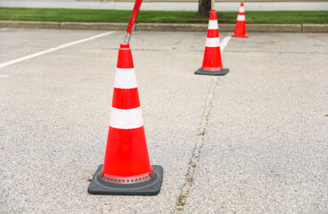 construction cone on the road signifies ongoing progress, caution, and temporary disruption in the journey ahead