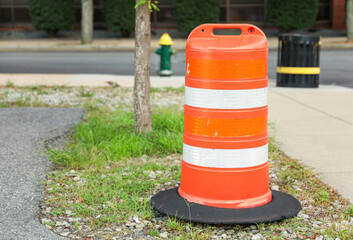 Fototapeta na wymiar construction cone on the road signifies ongoing progress, caution, and temporary disruption in the journey ahead