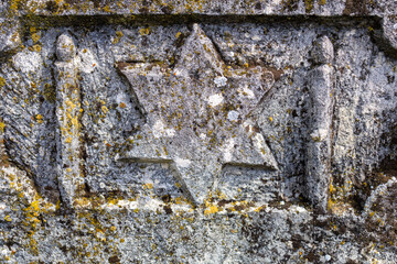 Jewish star on the tombstone. Background with selective focus