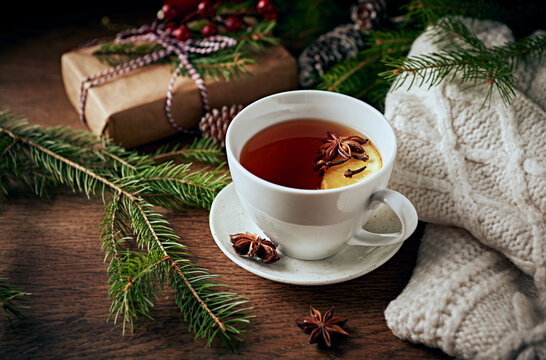 Cup of hot tea with orange and spices for winter and Christmas  time