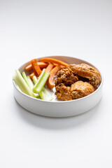 Chicken Wing Dinner with Carrots and Celery Side on Solid White Background