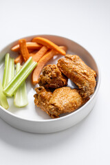 Chicken Wing Dinner with Carrots and Celery Side on Solid White Background