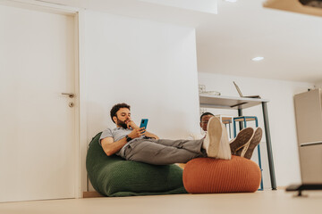 Multiracial coworkers lying on lazy bags taking a break from work.