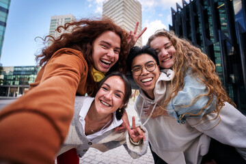 Group of multiracial young people having fun taking a selfie in the city with a smartphone. Happy...