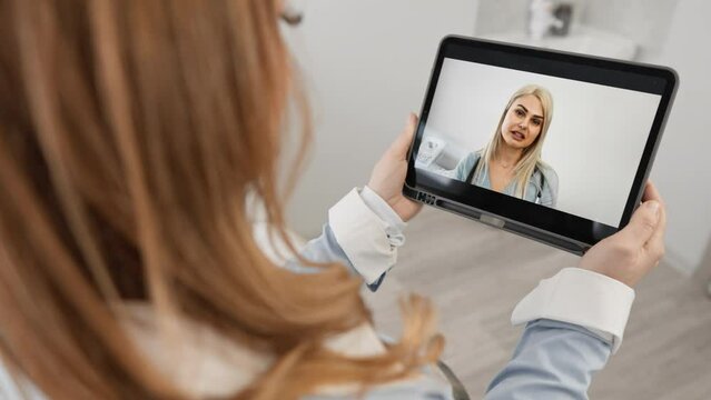 The doctor and the patient discuss possible diagnoses and jointly determine the optimal action plan for improving health remotely via video chat on a tablet. Online hospital and medical care