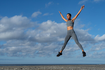 Fototapeta premium athletic brunette girl doing fitness doing exercises leading a healthy lifestyle