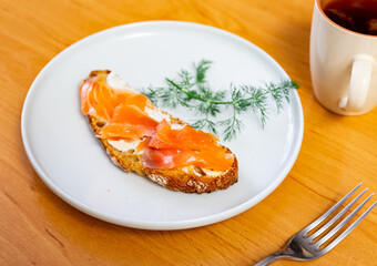 Appetizing salmon sandwich served on dish in restaurant