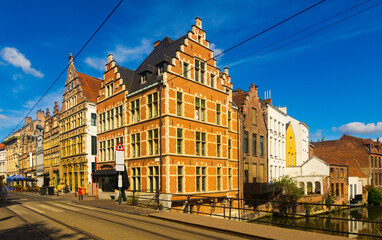 Naklejka na ściany i meble Vibrant street view of downtown Ghent, capital city of east Flanders province, Belgium along Leie river