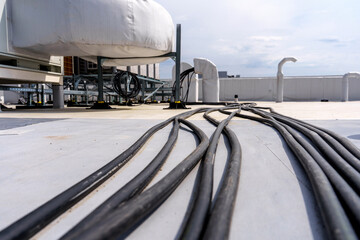 Laying cables and wires on the roof of an industrial building