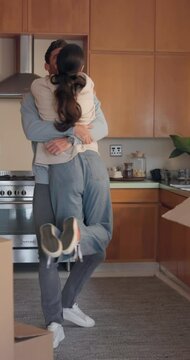 Mortgage, kiss and hug with a couple in their new home together for celebration or real estate investment. Love, property or growth with an excited man and woman embracing while moving house