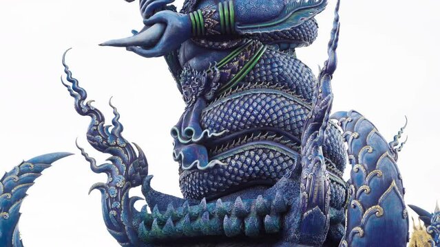 details of warrior sculpture on the gate of Wat Rong Suea Ten - blue temple in Chiang rai, thailand