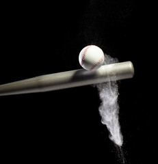 Baseball player hit ball with silver bat and sand soil explode in air. Baseball players in dynamic...