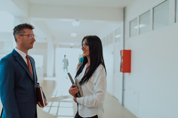 Business colleagues engage in a knowledge-sharing conversation during a coffee break in a modern corporate environment, exemplifying professional collaboration and skill enhancement within a bustling