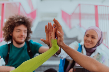A diverse group of students symbolizes unity as they interlace their hands, portraying a sense of...