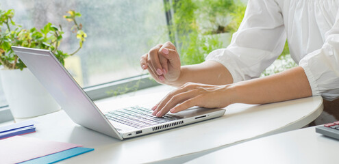 close-up of female hands in an office setting with a laptop .person working on a laptop in the office close-up of hands.business banking economy accounting finance analytics audit concept.