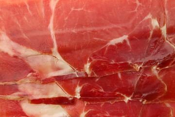 Delicious sliced jamon as background, top view
