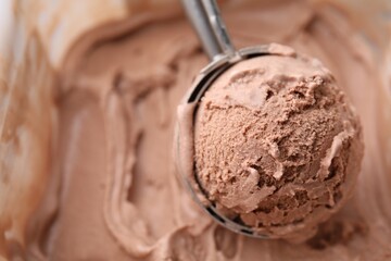Taking tasty chocolate ice cream with scoop as background, closeup. Space for text