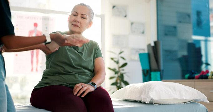 Woman, physical therapy and check arm in clinic for medical consulting, rehabilitation or healing muscle. Physiotherapist, senior patient and healthcare for chiropractic support, mobility or recovery