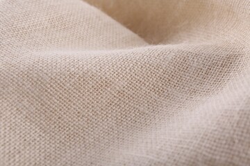 Texture of beige burlap fabric, closeup view