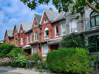 Urban residential street with colorful Victorian row houses with ponty gables