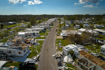 Badly damaged mobile homes after hurricane Ian in Florida residential area. Consequences of natural disaster