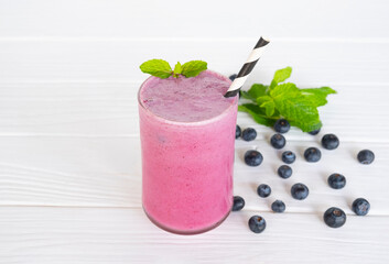 Blueberry Juice smoothies drink in a glass drink purple colorful fruit juice milkshake blend beverage healthy high protein the taste yummy in glass on white wood background.