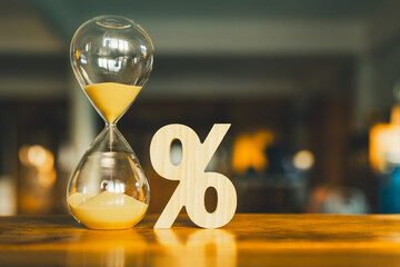 Percentage symbol and hourglass, concept of tax and loan interest, deposit interest, income or...