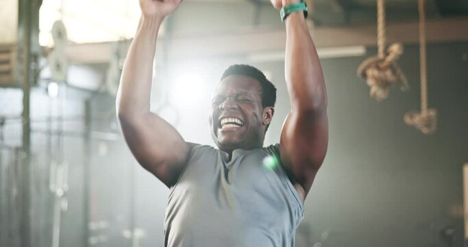 Sports, gymnastics and black man doing pull up exercise for arm muscle training or workout in gym. Fitness, bodybuilding and African male athlete doing an intense strength challenge in health center.