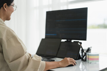 Developer programmer checking code on multiple monitor while programming to developing web and apps