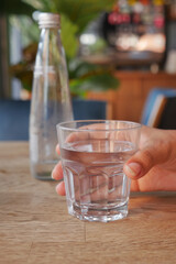 holding a glass of water with copy space 