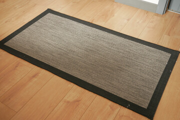 Seamless grey carpet texture background on wooden floor with copy space 