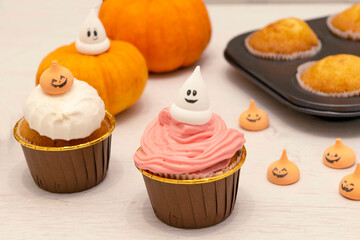 freshly made cupcakes or maffins decoreted with cream at the kitchen