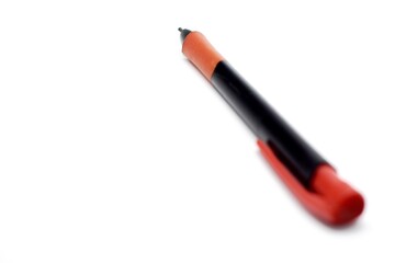 a mechanical pencil with red and black colors photographed on the isolated white background