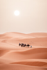 Camel trek during sunrise with tourists in the sahara desert, Merzouga Morocco