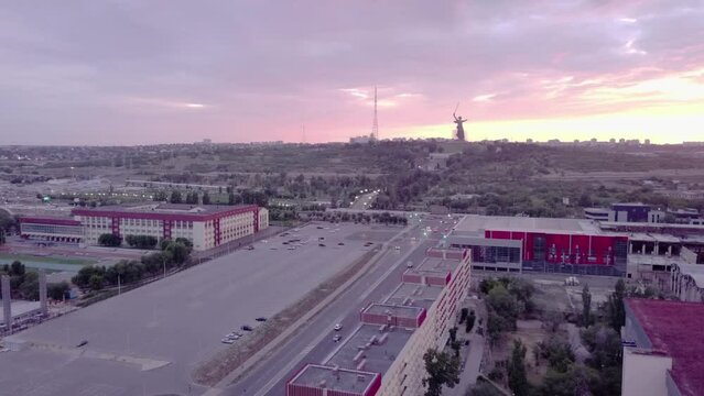 Aerial shot travelling over apartment buildings and empty carpark to The Motherland Calls Statue in Volgograd, Russia.