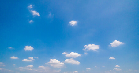 Panoramic view of clear blue sky and clouds, Blue sky background with tiny clouds. White fluffy clouds in the blue sky. Captivating stock photo featuring the mesmerizing beauty of the sky and clouds.