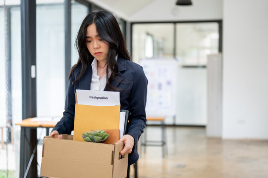 Sad And Upset Asian Female Office Worker Quitting A Job, Being Fired From Her Boss